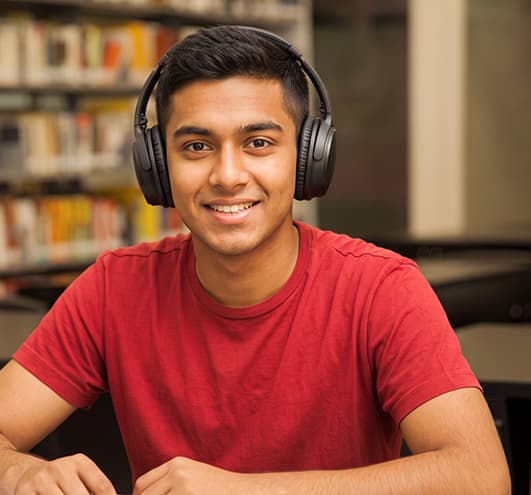 A student joining the class from home in headphones